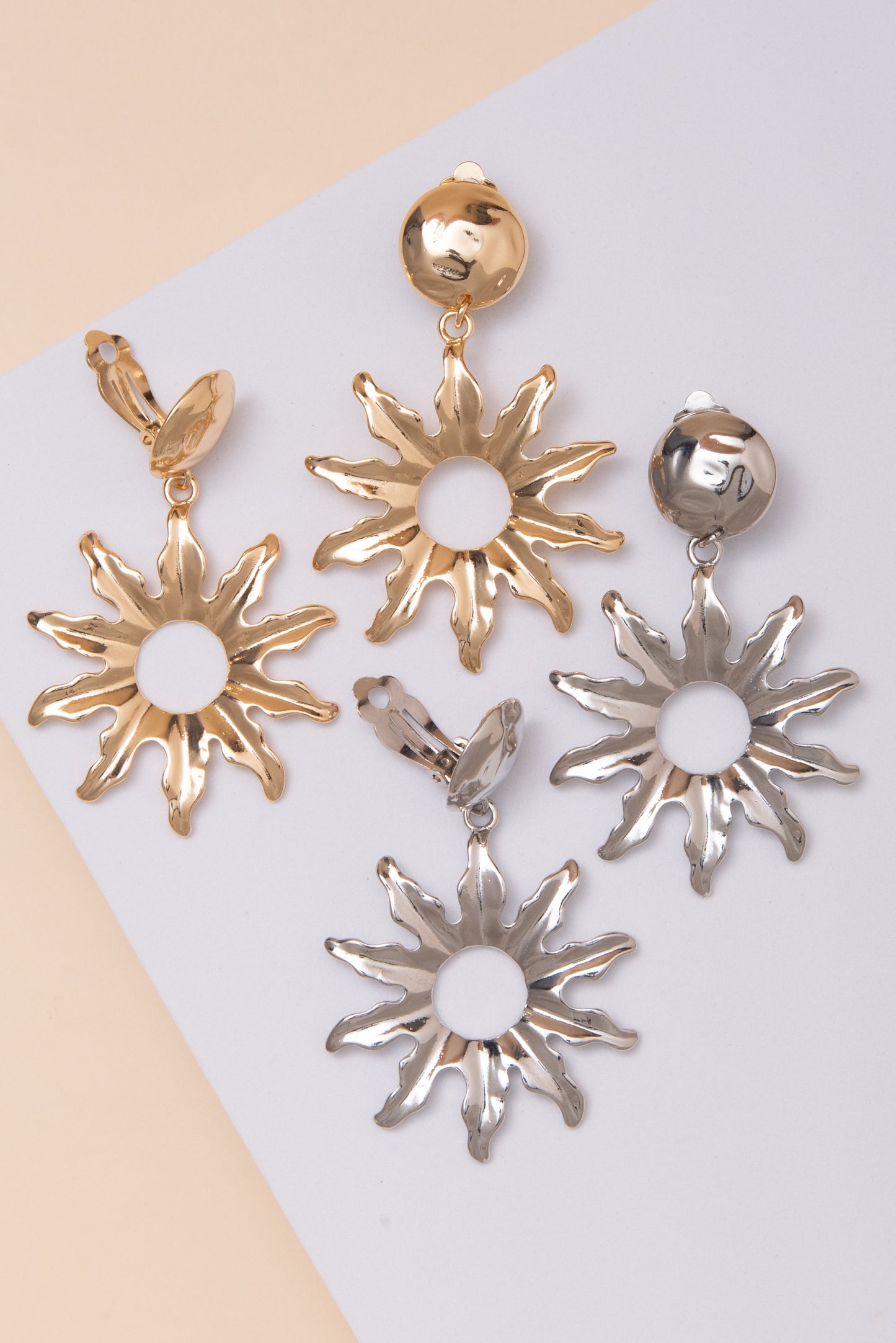 Rebecca Clip On Earrings with Metal Sunburst Cutout Drop